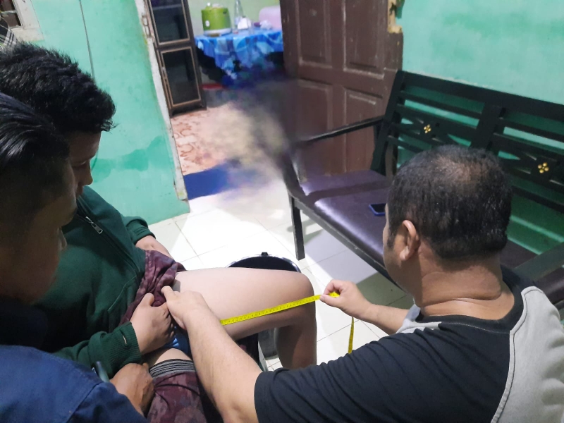 Ketua Umum BFLF Indonesia Michael O Alexander Chan Melakukan Pengukuran Kaki Kepada Nafis Alfian Penyandang Disabilitas